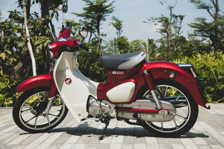 A vintage-style red Honda Super Cub motorcycle parked outdoors in Vietnam